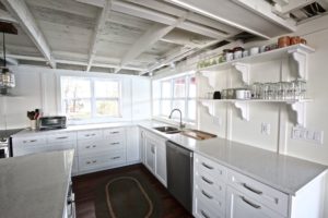 Stoney Lake cottage renovation - kitchen looking out windows to lake